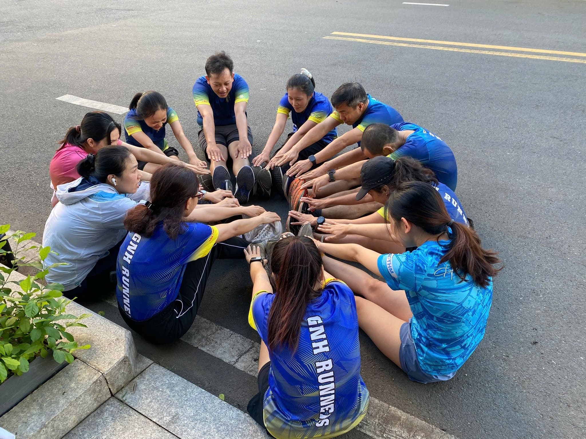 Family sitting around a fire pit in front of cabin
